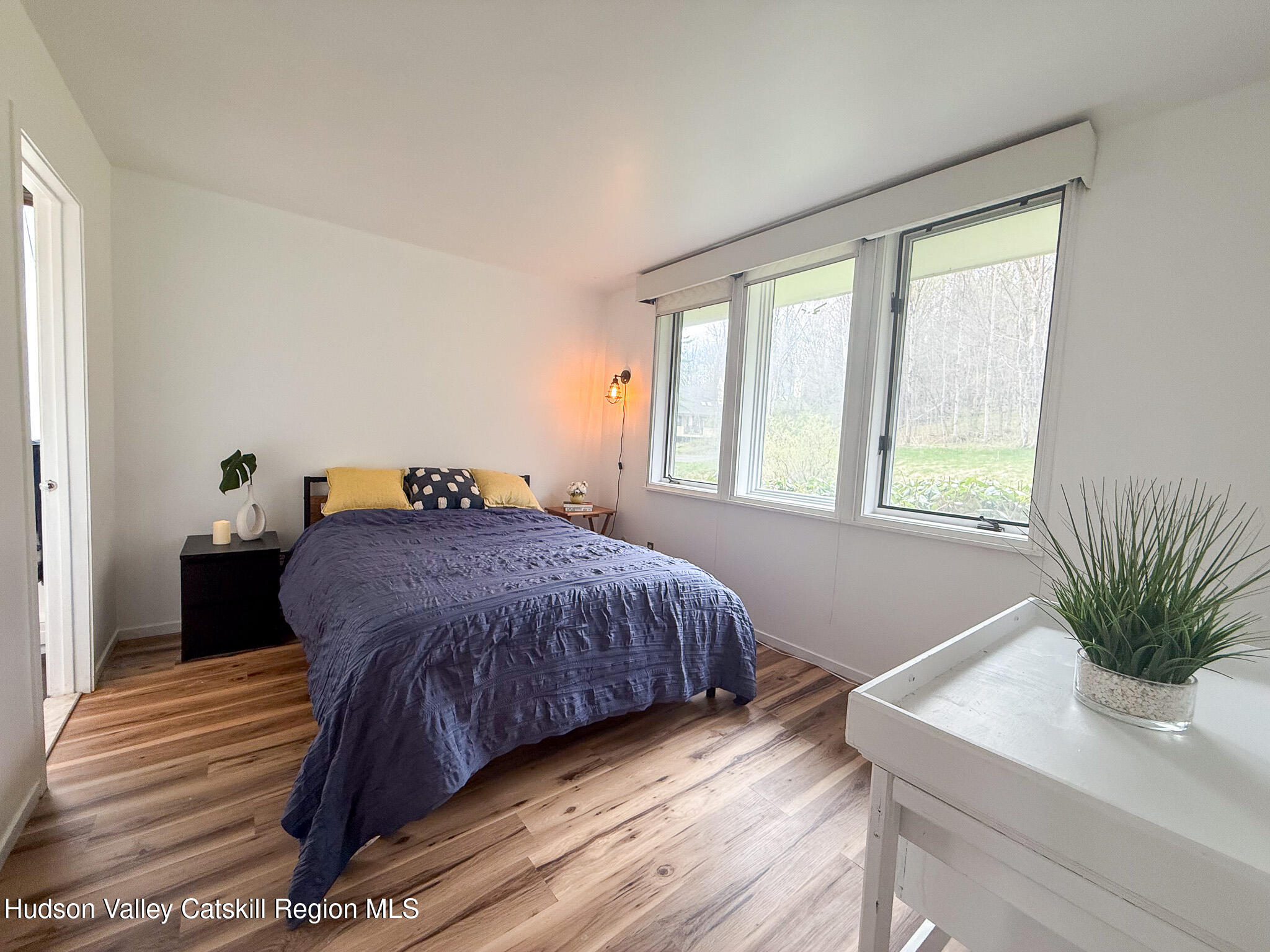 130 Pines Drive, Unit 59 Roxbury, NY 12421 - Photo 18 of 34 a bed sitting in a bedroom next to a window