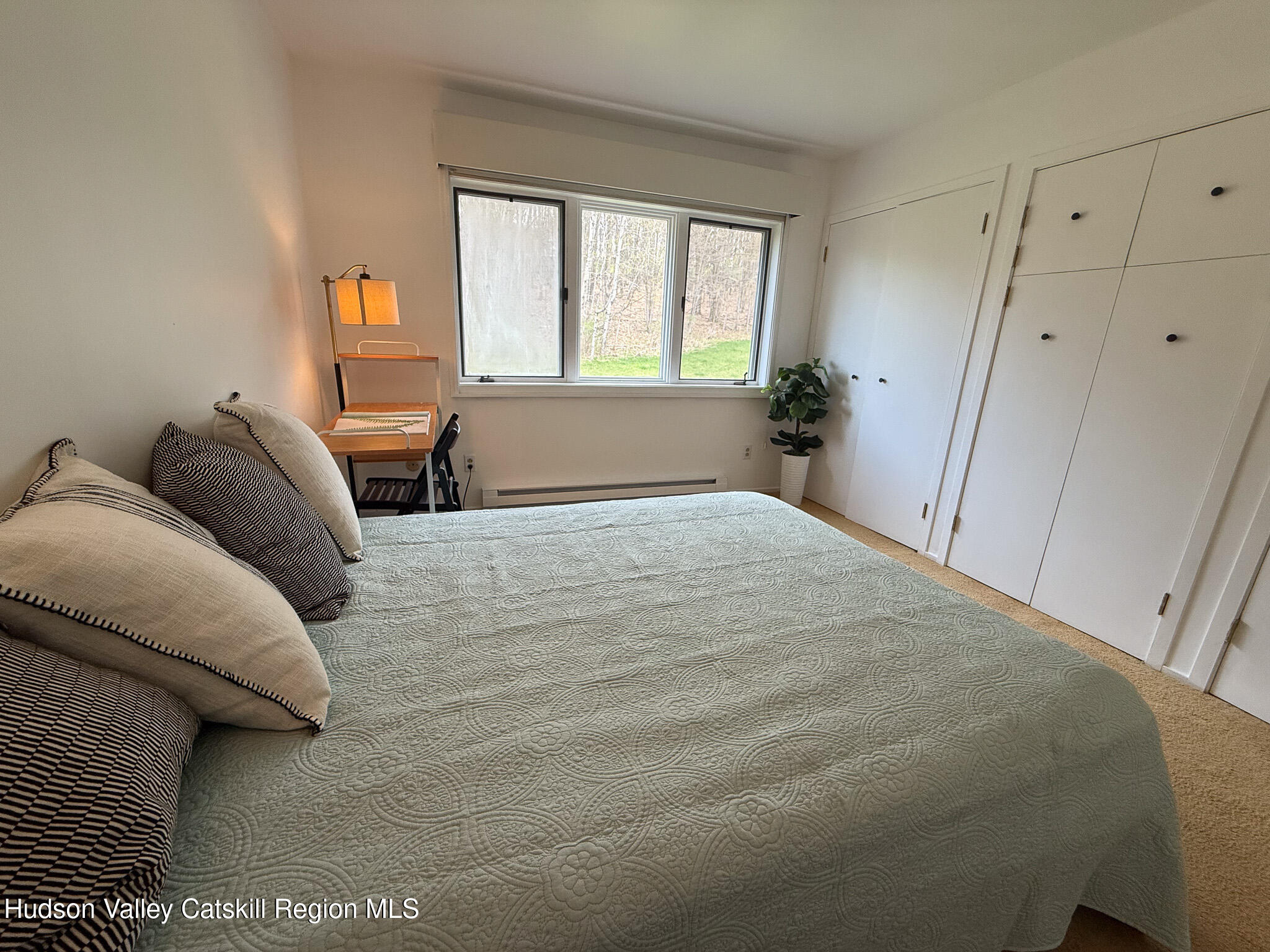 130 Pines Drive, Unit 59 Roxbury, NY 12421 - Photo 25 of 34 a bedroom with a bed and wooden floor