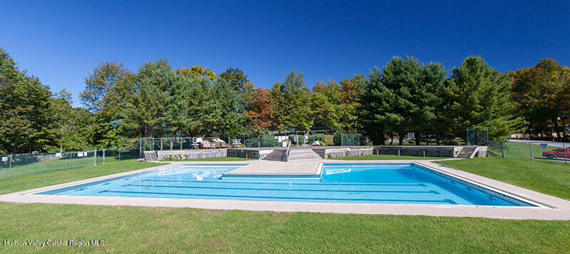130 Pines Drive, Unit 59 Roxbury, NY 12421 - Photo 33 of 34 a view of a swimming pool with a yard