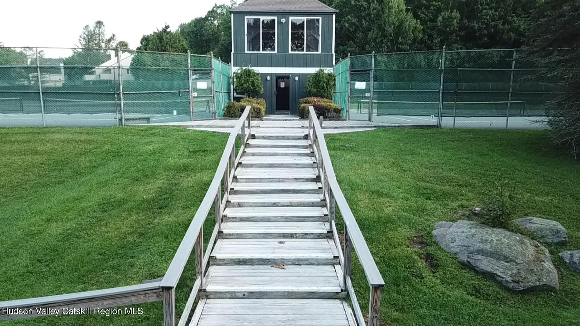 130 Pines Drive, Unit 59 Roxbury, NY 12421 - Photo 8 of 34 a front view of a house with a yard