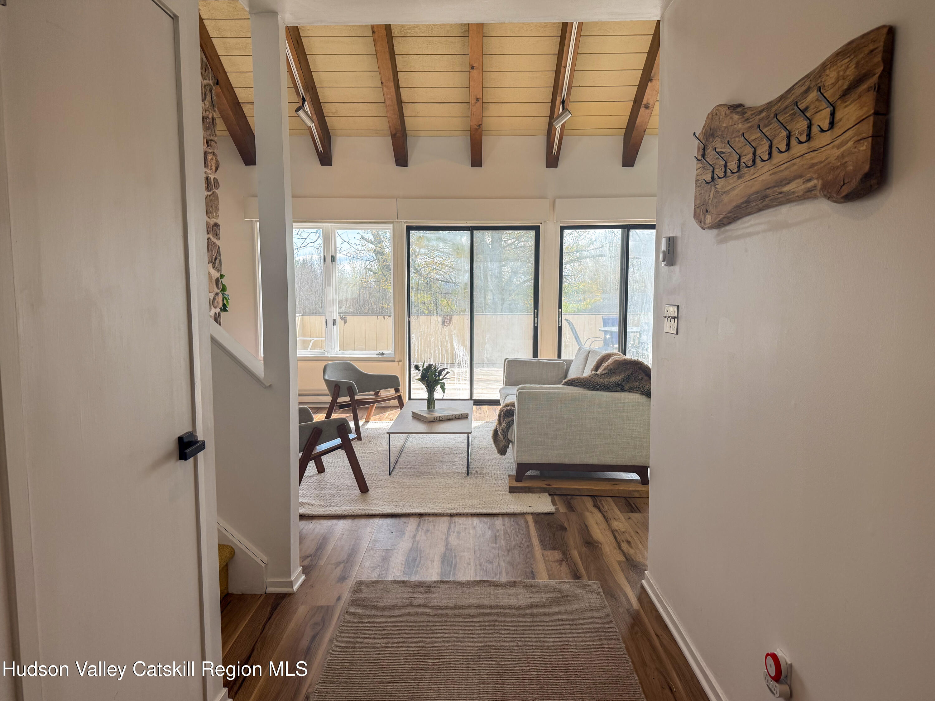 130 Pines Drive, Unit 59 Roxbury, NY 12421 - Photo 9 of 34 a living room with furniture and a floor to ceiling window