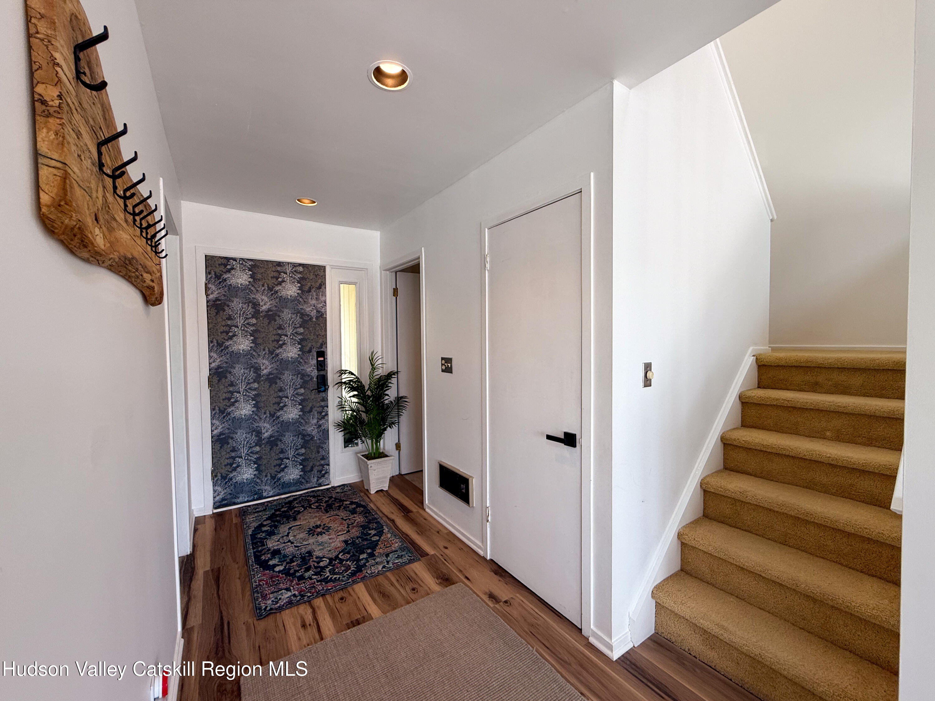 130 Pines Drive, Unit 59 Roxbury, NY 12421 - Photo 10 of 34 a view of a hallway with wooden floor and stairs