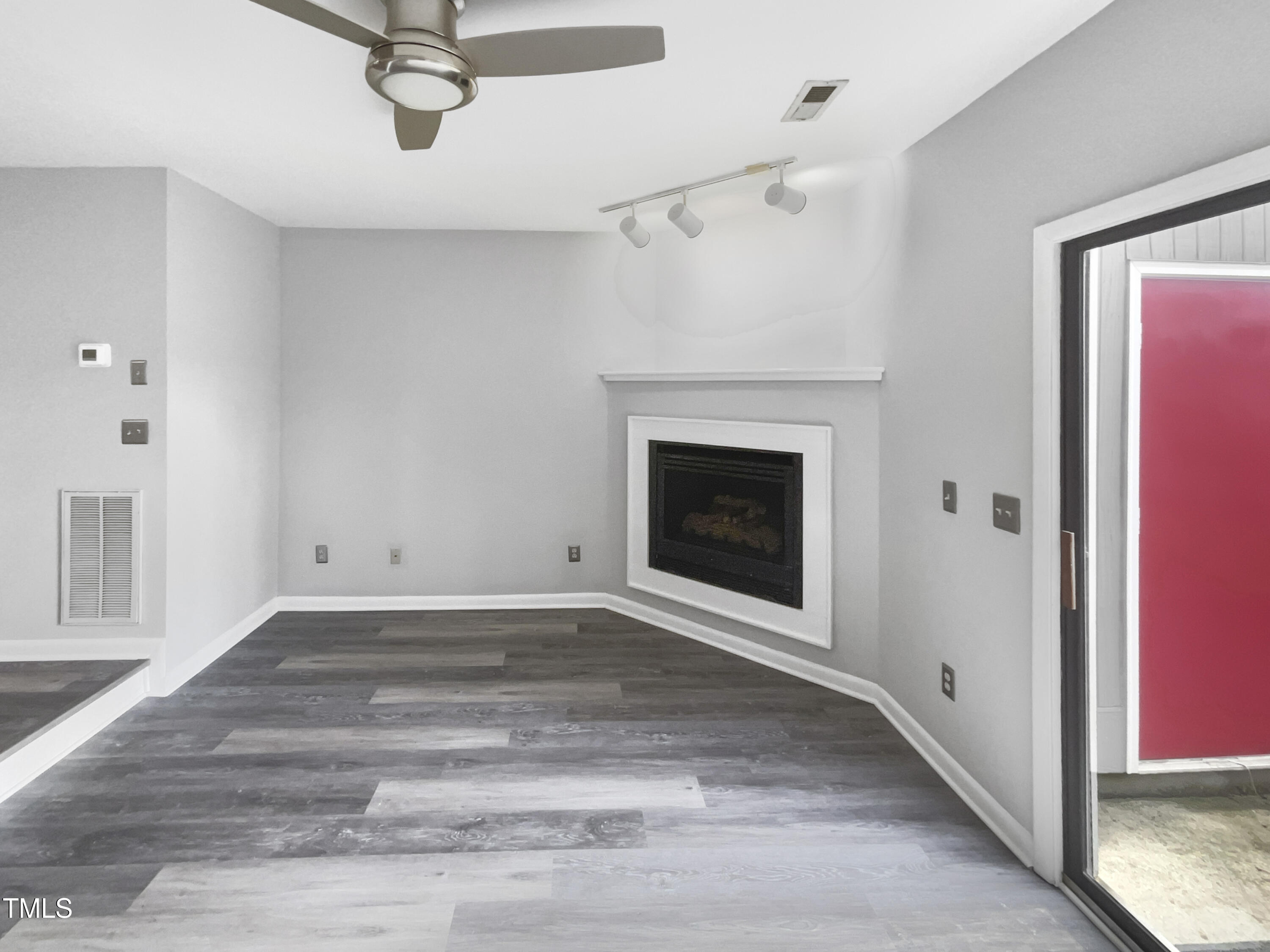 4213 Sunscape Lane Raleigh, NC 27613 - Photo 3 of 19 a view of an empty room with a fireplace and a window