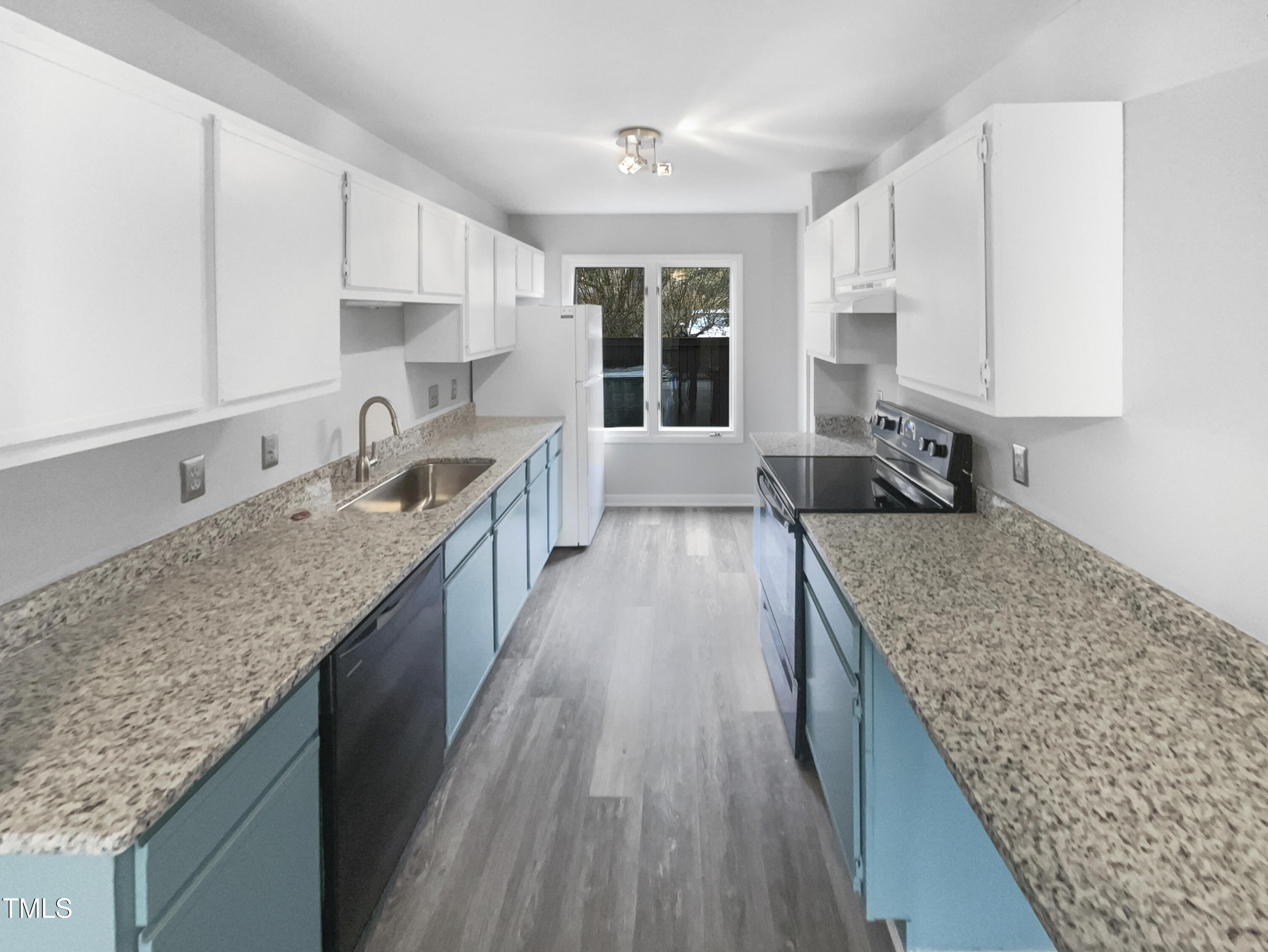 4213 Sunscape Lane Raleigh, NC 27613 - Photo 6 of 19 a large kitchen with kitchen island granite countertop a sink counter space and cabinets