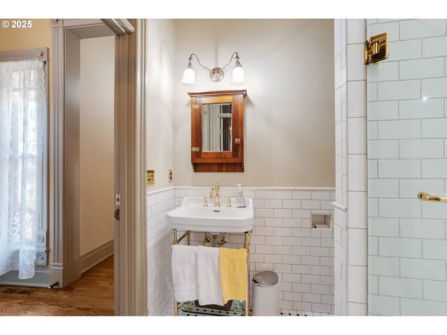 a bathroom with a sink mirror and vanity