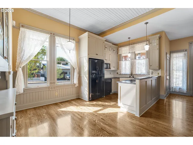 a kitchen with refrigerator and cabinets