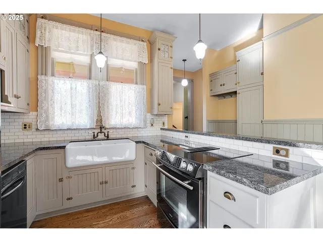 a kitchen with a sink stove and cabinets