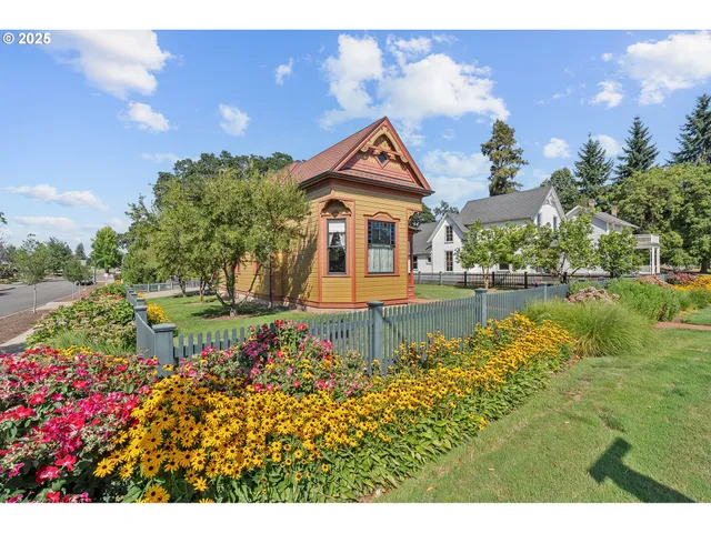 a front view of a house with a yard and potted plants