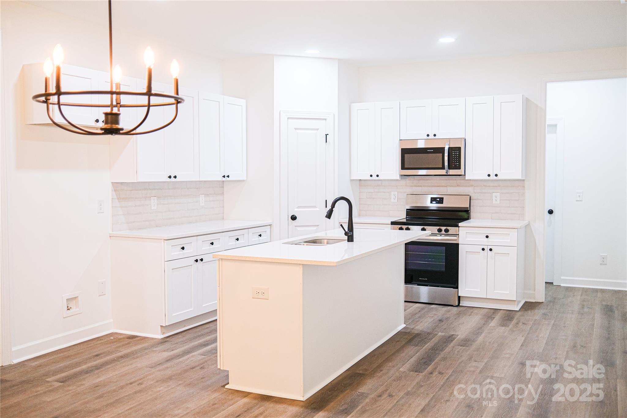 400 1/2 South Yadkin Avenue Spencer, NC 28159 - Photo 3 of 16 a kitchen with appliances a sink and cabinets