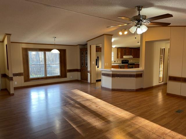 2740 Rutrough Road Southeast Roanoke, VA 24014 - Photo 2 of 27 a living room with stainless steel appliances kitchen island granite countertop a stove a sink dishwasher and a fireplace with wooden floor
