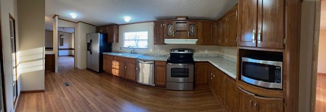 2740 Rutrough Road Southeast Roanoke, VA 24014 - Photo 14 of 27 a kitchen with stainless steel appliances granite countertop a refrigerator a stove and a wooden floors