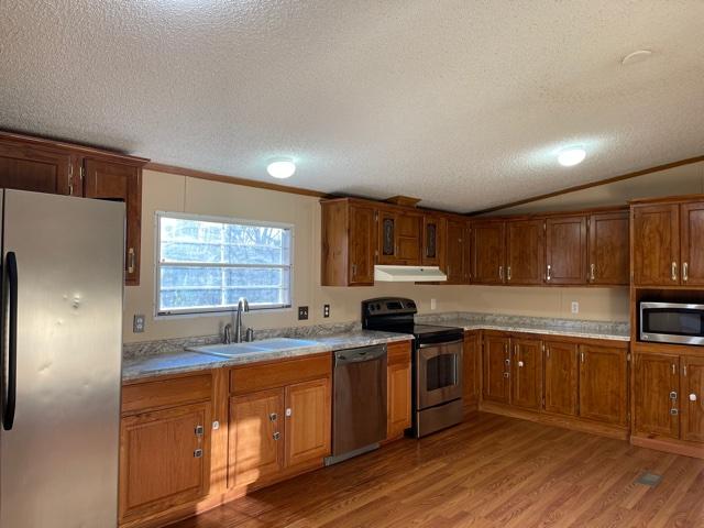 2740 Rutrough Road Southeast Roanoke, VA 24014 - Photo 17 of 27 a kitchen with stainless steel appliances granite countertop a sink a stove a refrigerator cabinets and a window