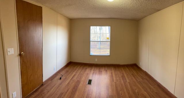 2740 Rutrough Road Southeast Roanoke, VA 24014 - Photo 18 of 27 an empty room with wooden floor and windows