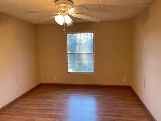 2740 Rutrough Road Southeast Roanoke, VA 24014 - Photo 19 of 27 a view of an empty room with wooden floor and a window