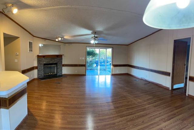 2740 Rutrough Road Southeast Roanoke, VA 24014 - Photo 10 of 27 an empty room with wooden floor fireplace and windows
