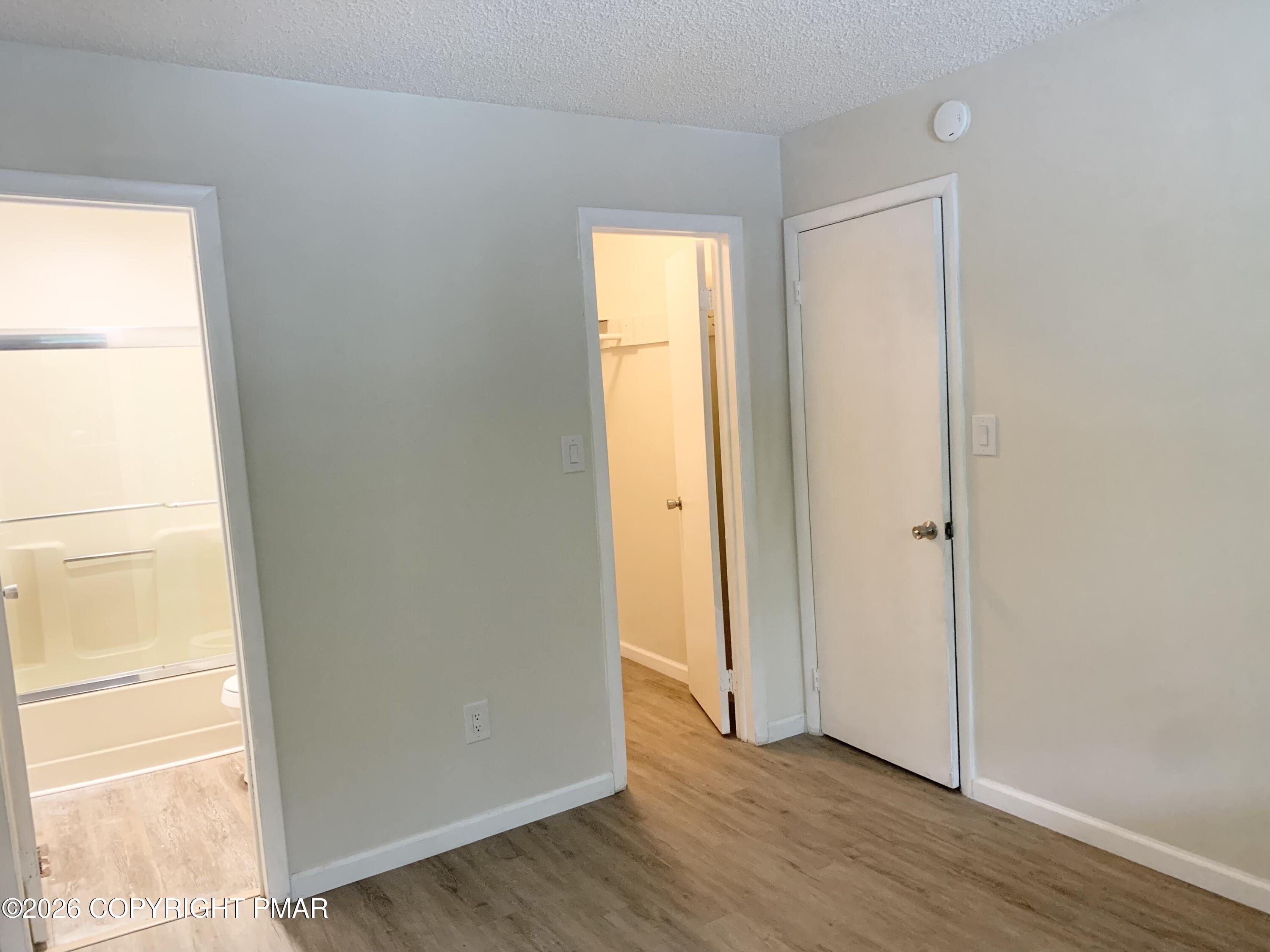 130 View Court, Unit 101 Mount Pocono, PA 18344 - Photo 4 of 8 a view of an empty room with wooden floor and a window