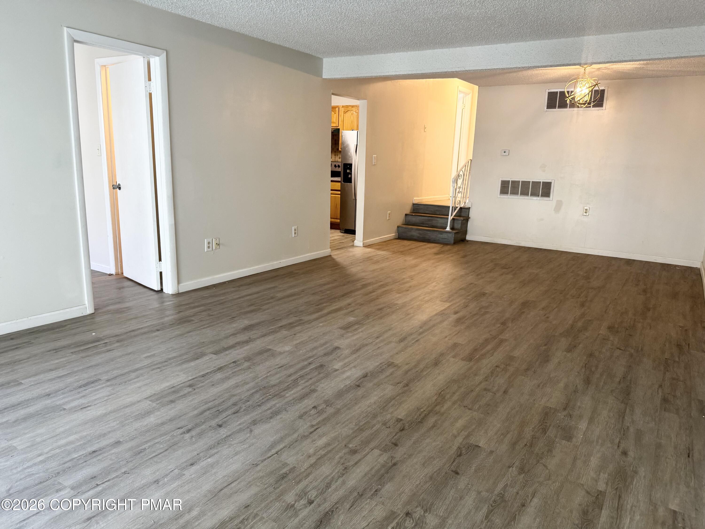 130 View Court, Unit 101 Mount Pocono, PA 18344 - Photo 5 of 17 a view of a room with wooden floor and a window