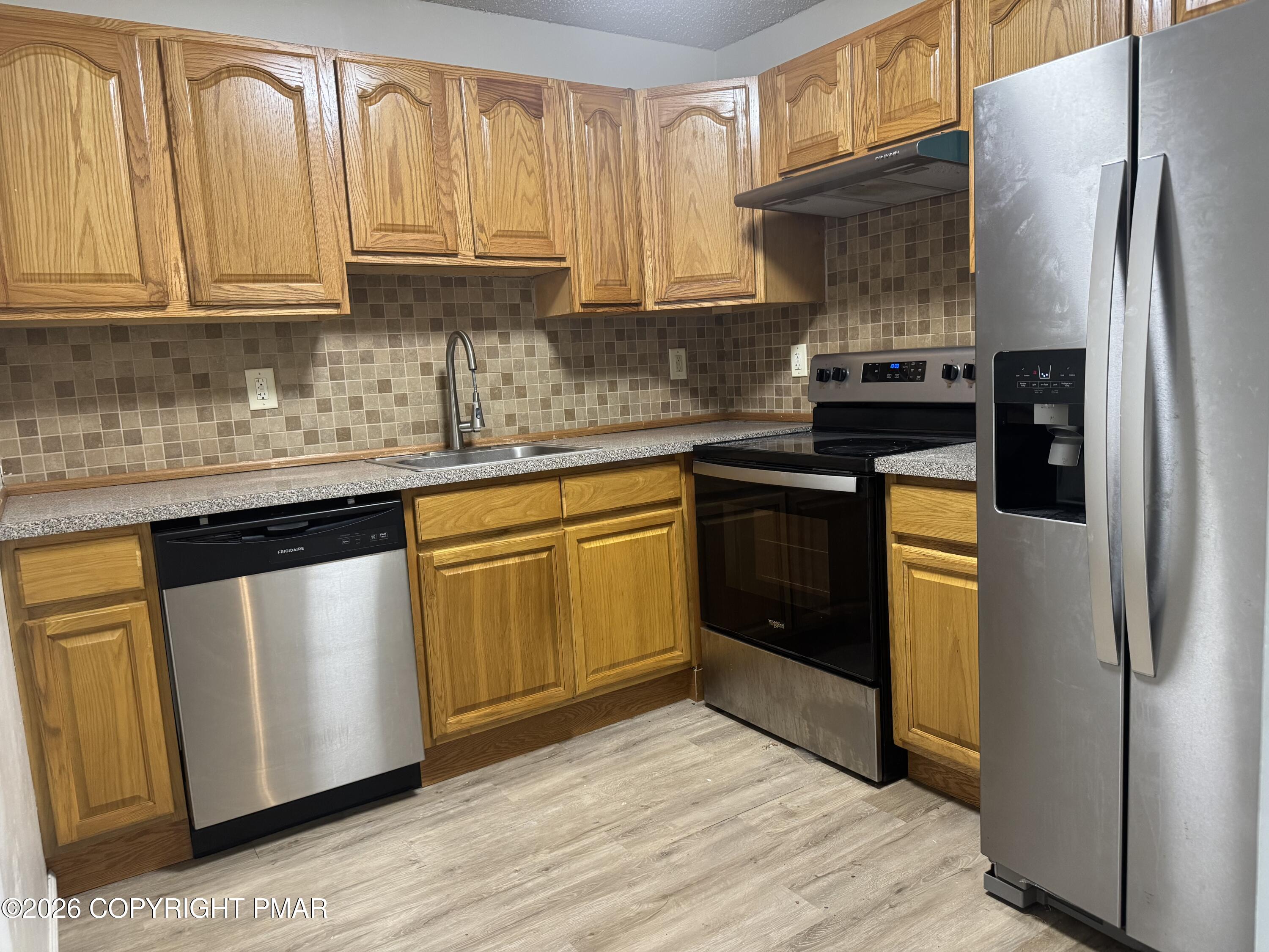 130 View Court, Unit 101 Mount Pocono, PA 18344 - Photo 7 of 17 a kitchen with stainless steel appliances granite countertop a refrigerator sink and stove