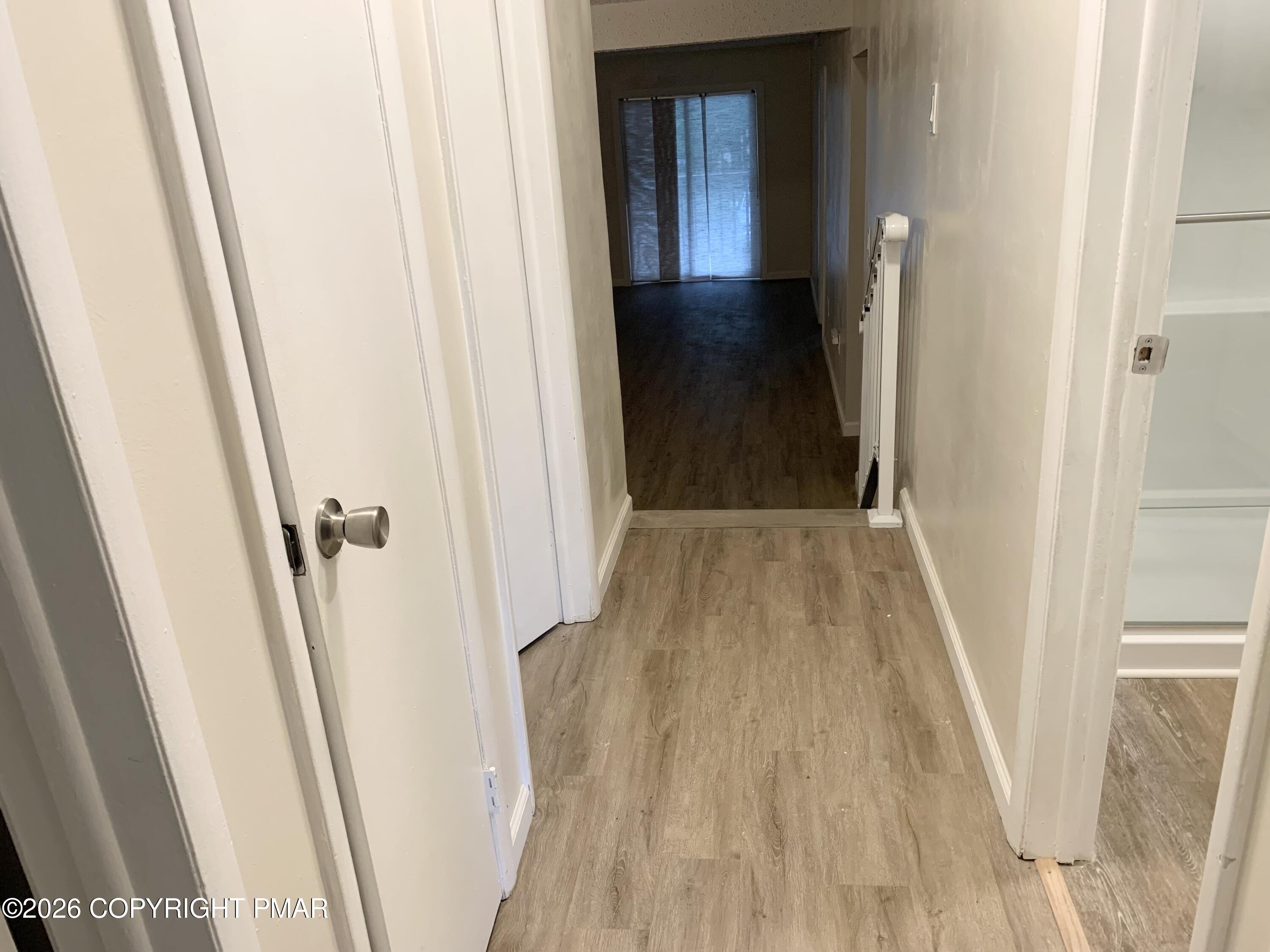 130 View Court, Unit 101 Mount Pocono, PA 18344 - Photo 8 of 8 a view of a hallway with wooden floor and staircase