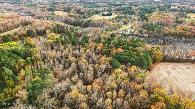an aerial view of residential house with yard and parking space
