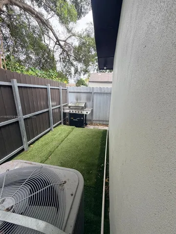 a backyard of a house with table and chairs