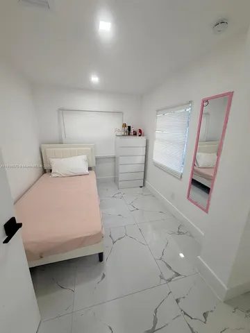 a bedroom with a bed and walk in closet