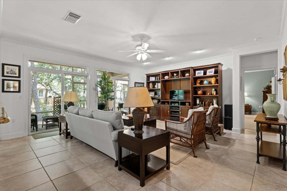 503 Breezeway Lane Georgetown, TX 78633 - Photo 4 of 38 An inviting living room features elegant tile flooring and a view to a serene outdoor space.