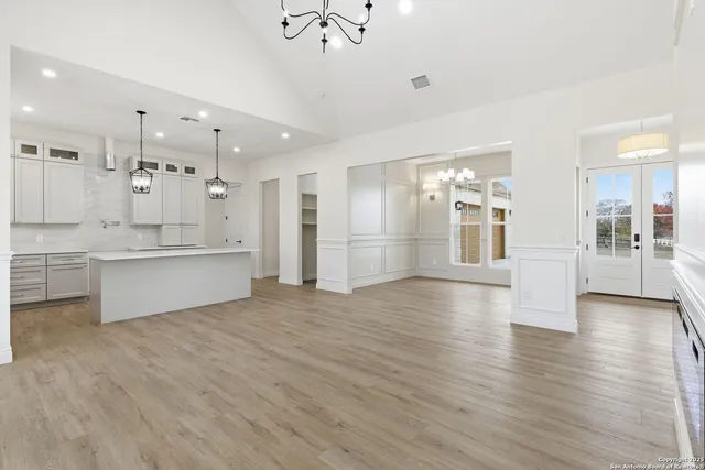 a view of a kitchen with a kitchen island wooden floor and a refrigerator