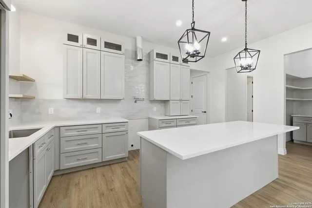a kitchen with white cabinets and white appliances
