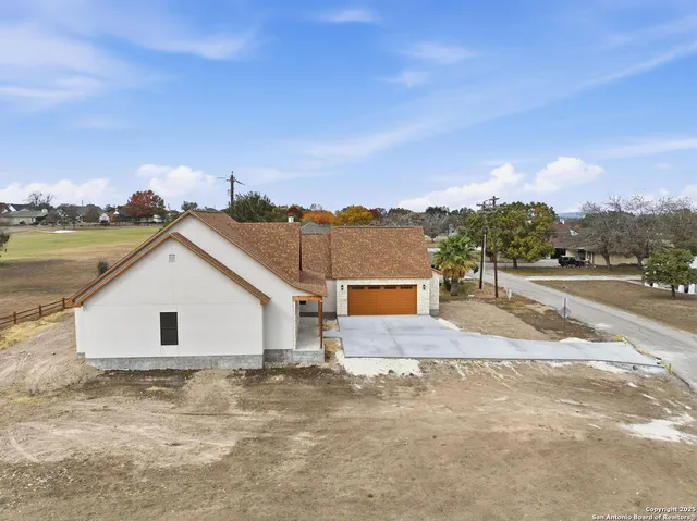 an aerial view of residential houses with outdoor space