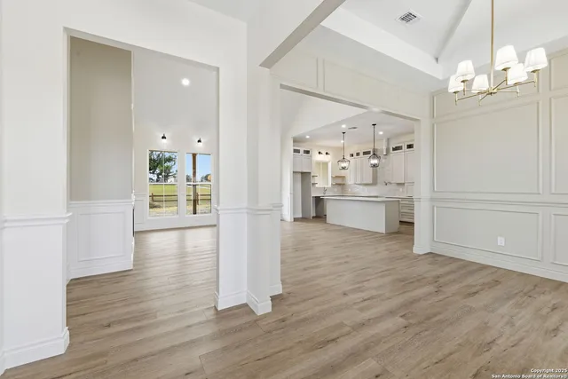 a view of a kitchen with a refrigerator and a stove top oven