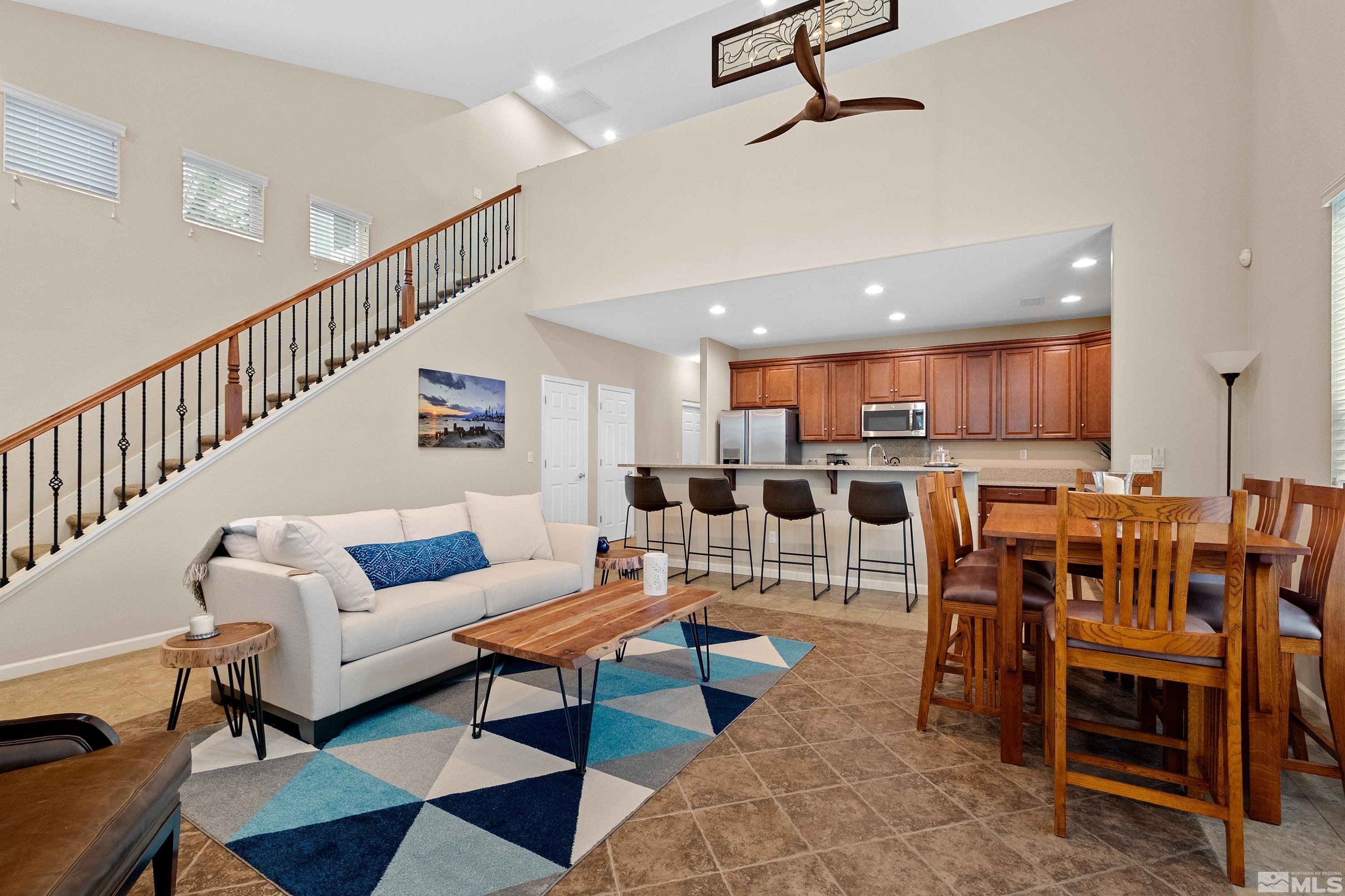 a living room with lots of furniture and kitchen view