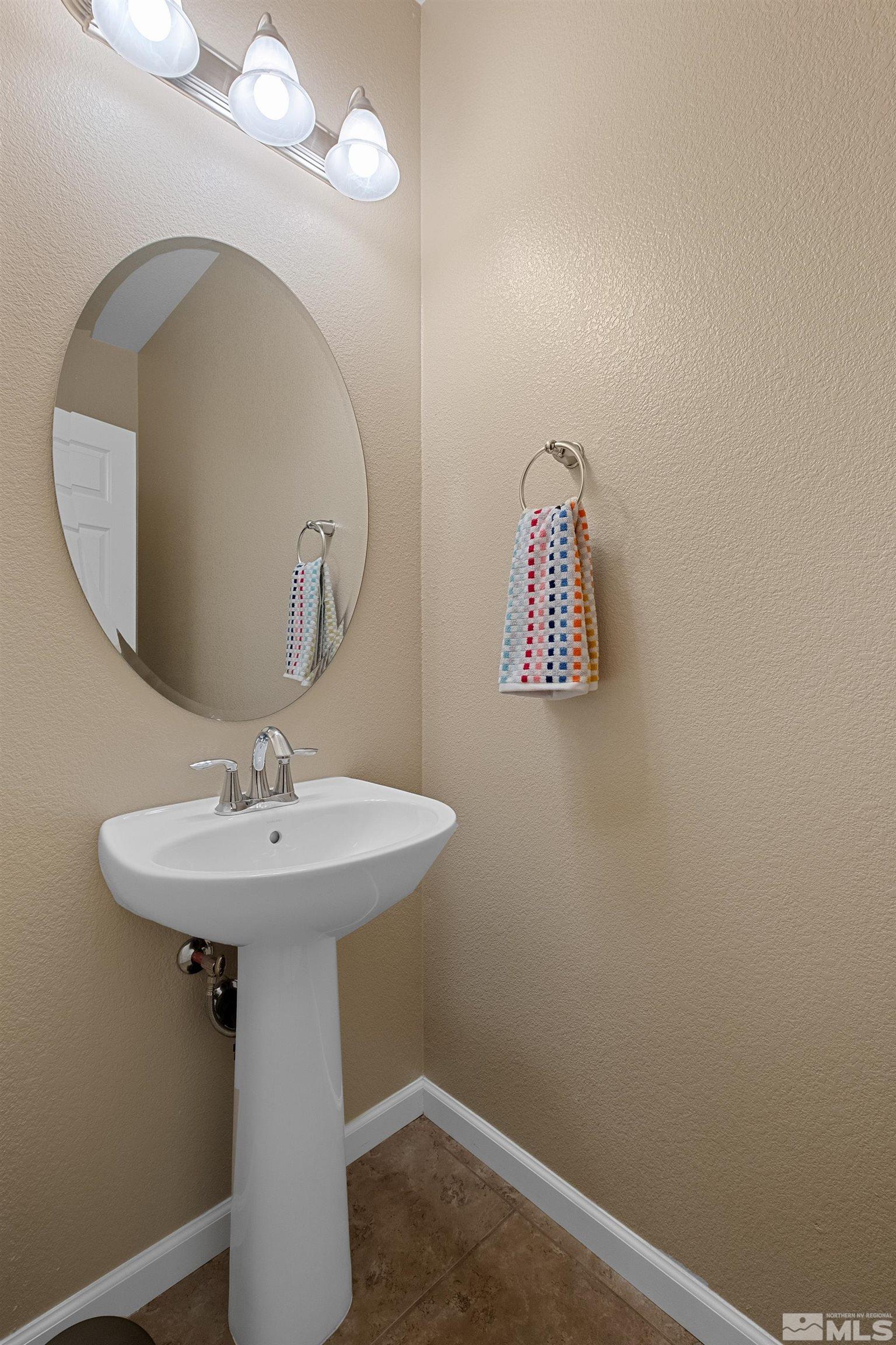 235 Brenham Avenue Reno, NV 89509 - Photo 14 of 32 a bathroom with a sink a mirror and vanity