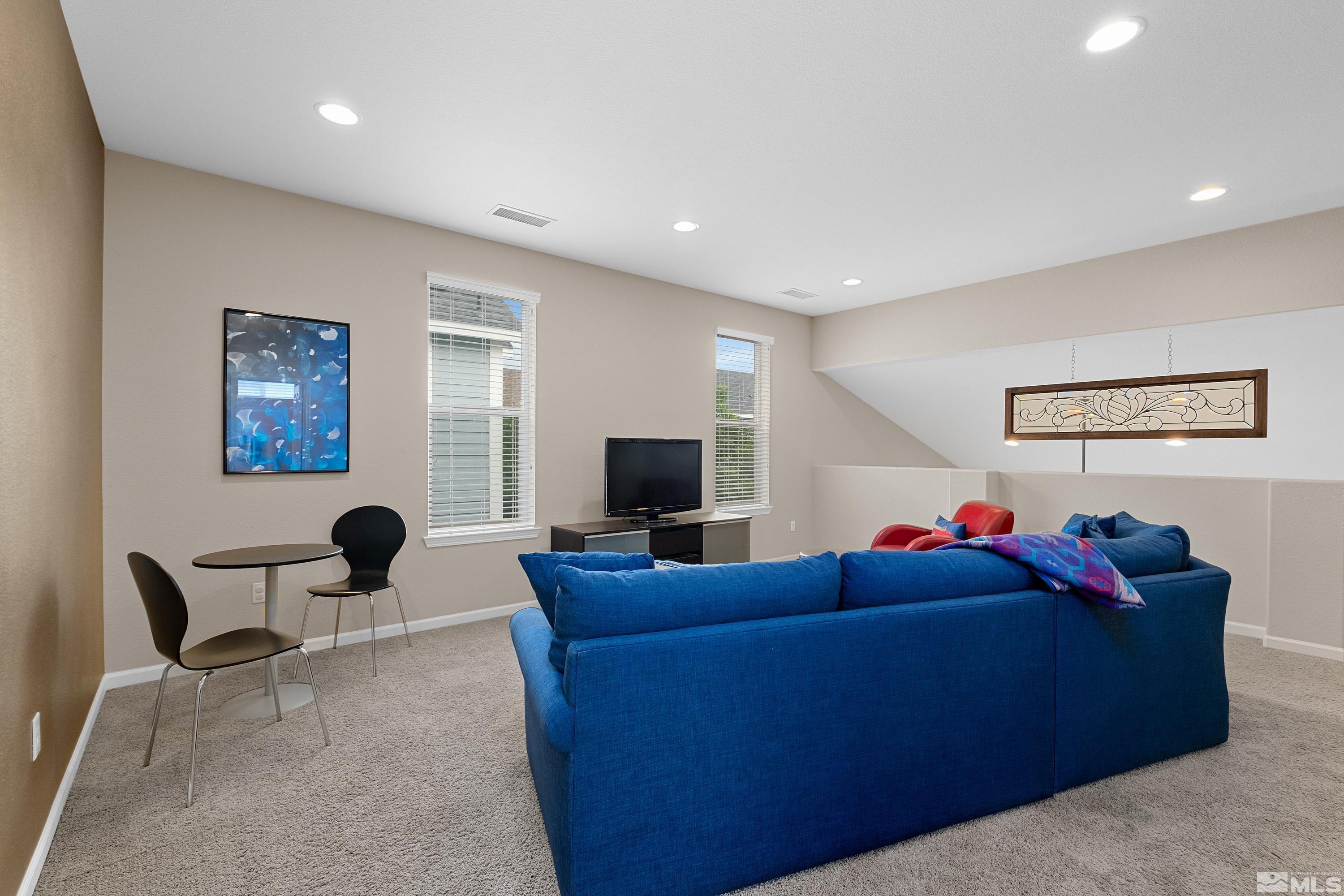 235 Brenham Avenue Reno, NV 89509 - Photo 17 of 32 a living room with furniture and a flat screen tv