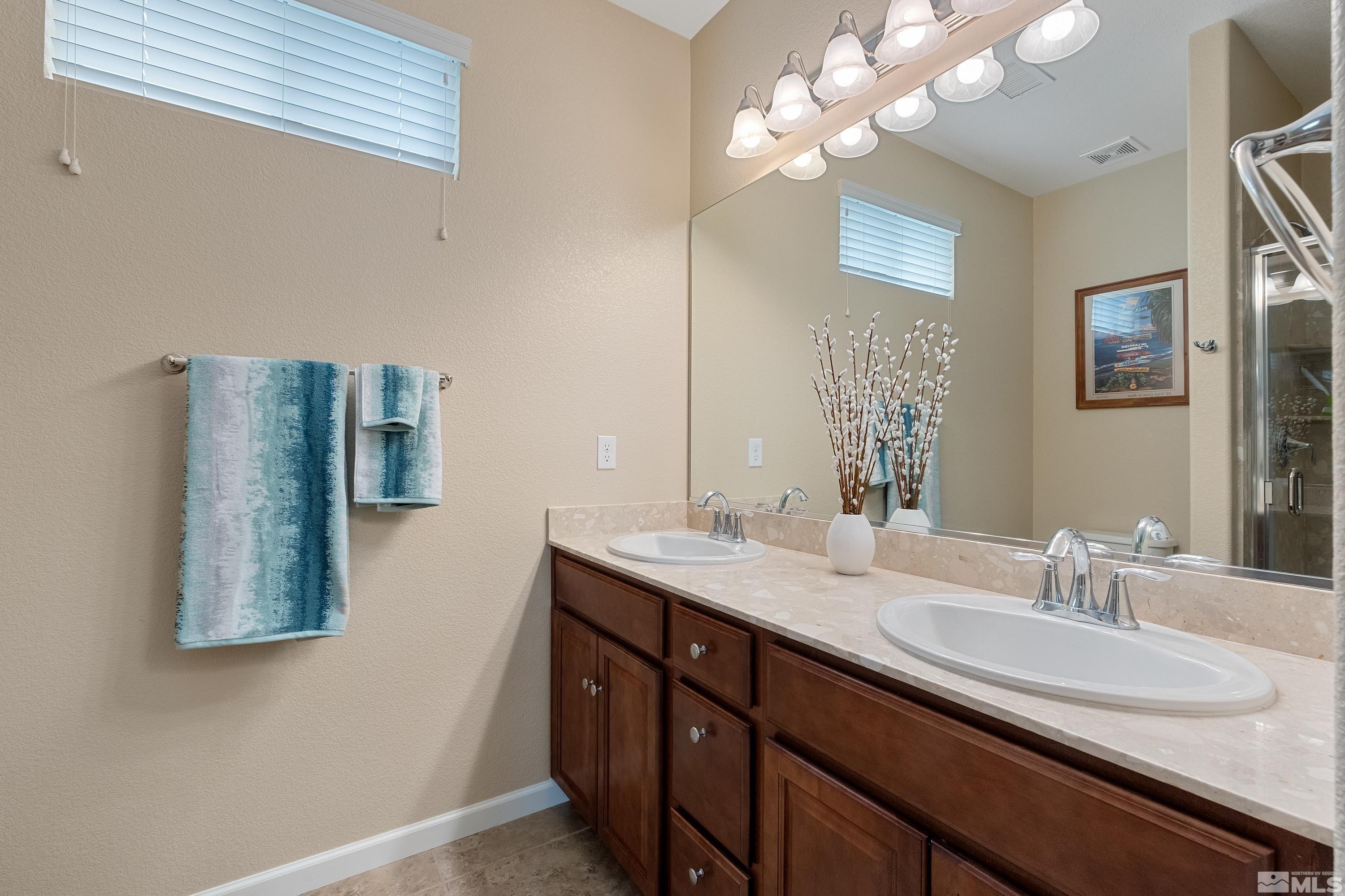 235 Brenham Avenue Reno, NV 89509 - Photo 20 of 32 a bathroom with a double vanity sink and a mirror