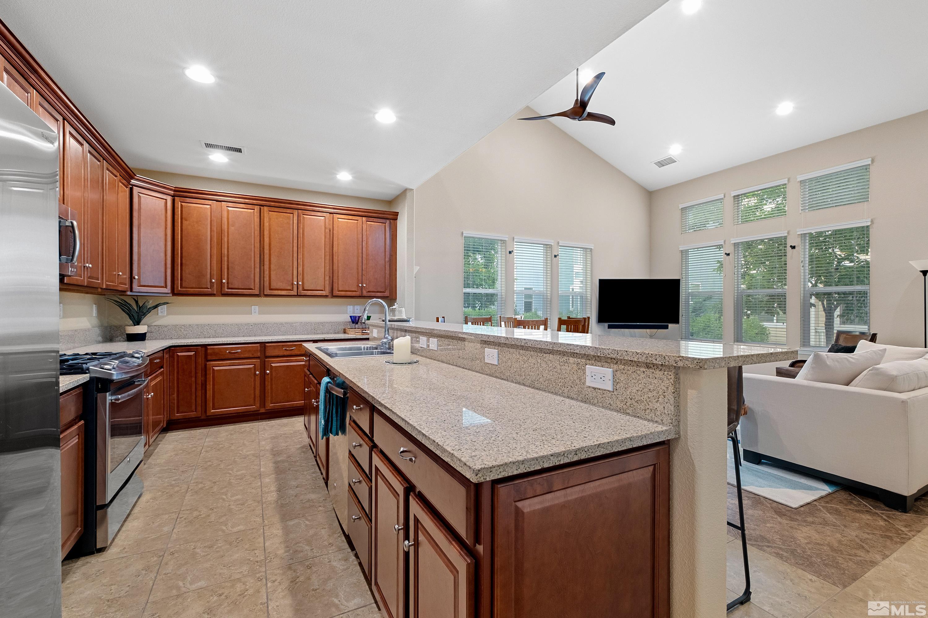 235 Brenham Avenue Reno, NV 89509 - Photo 4 of 32 a kitchen with a stove sink and a refrigerator