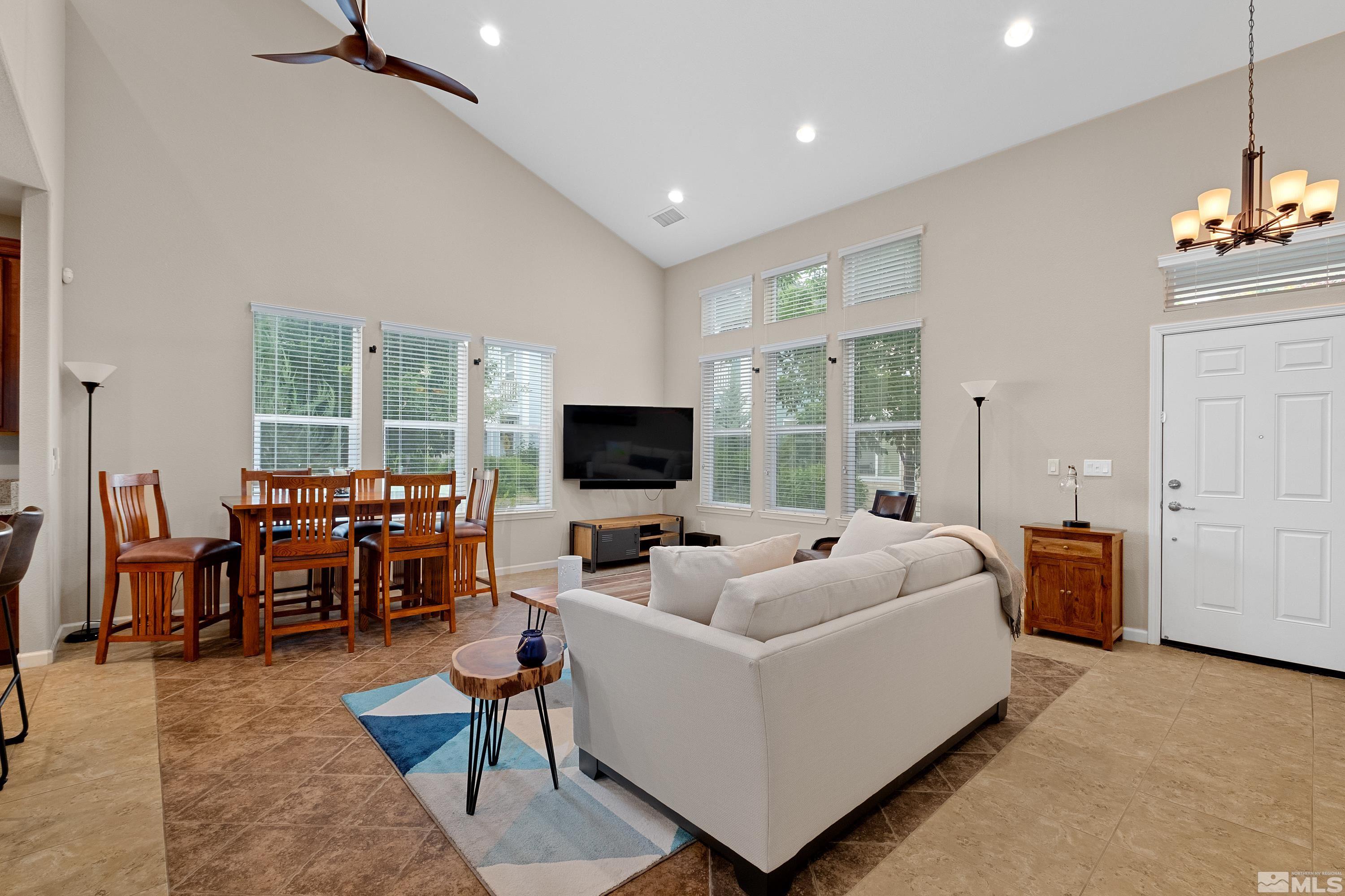 235 Brenham Avenue Reno, NV 89509 - Photo 7 of 32 a living room with furniture a flat screen tv and a large window