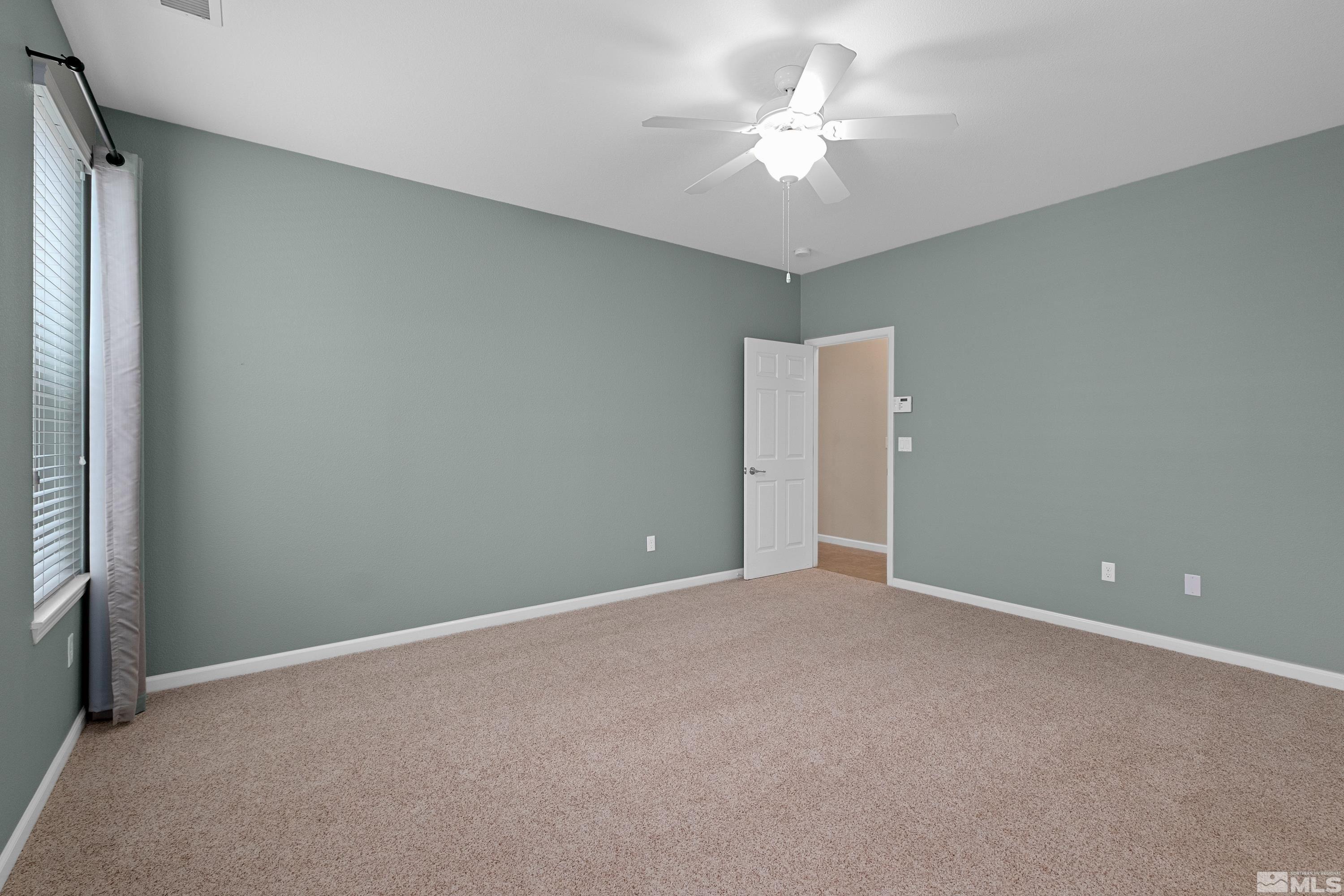 235 Brenham Avenue Reno, NV 89509 - Photo 9 of 32 a view of an empty room with a ceiling fan