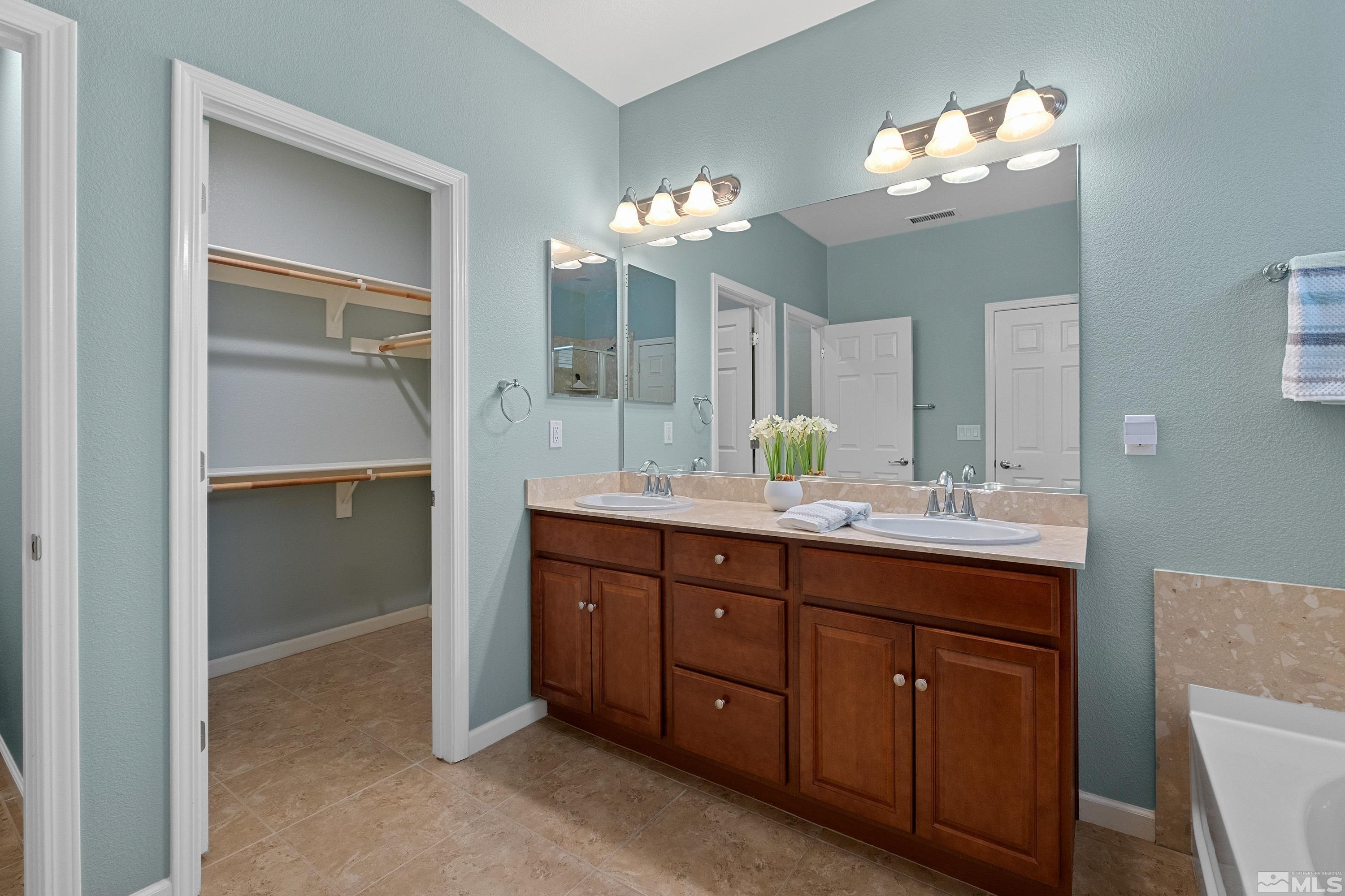 235 Brenham Avenue Reno, NV 89509 - Photo 10 of 32 a bathroom with a double vanity sink and a mirror