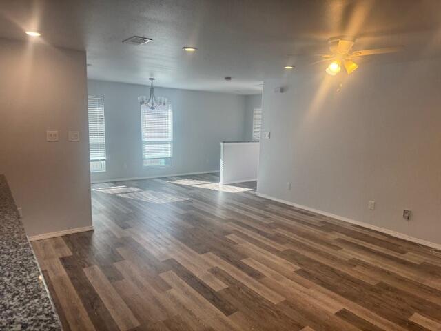 1106 North Englewood Avenue, Unit A&B Lubbock, TX 79416 - Photo 6 of 11 an empty room with wooden floor and windows