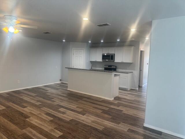 1106 North Englewood Avenue, Unit A&B Lubbock, TX 79416 - Photo 7 of 11 a kitchen with kitchen island a sink stainless steel appliances and cabinets
