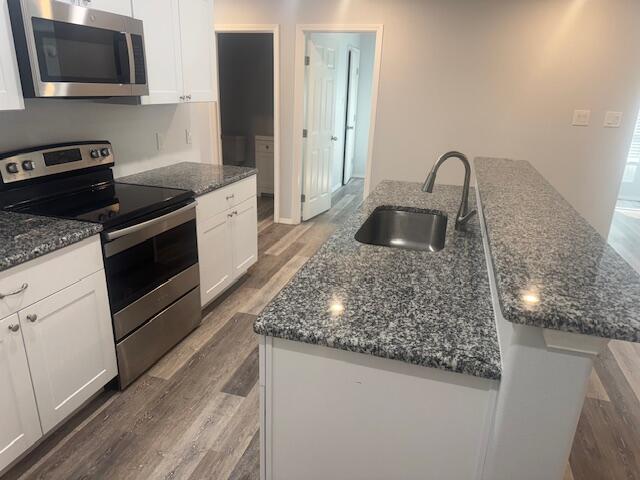 1106 North Englewood Avenue, Unit A&B Lubbock, TX 79416 - Photo 8 of 11 a kitchen with granite countertop a sink and a stove top oven