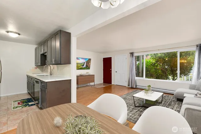 a spacious bedroom with a bed a couch and dresser