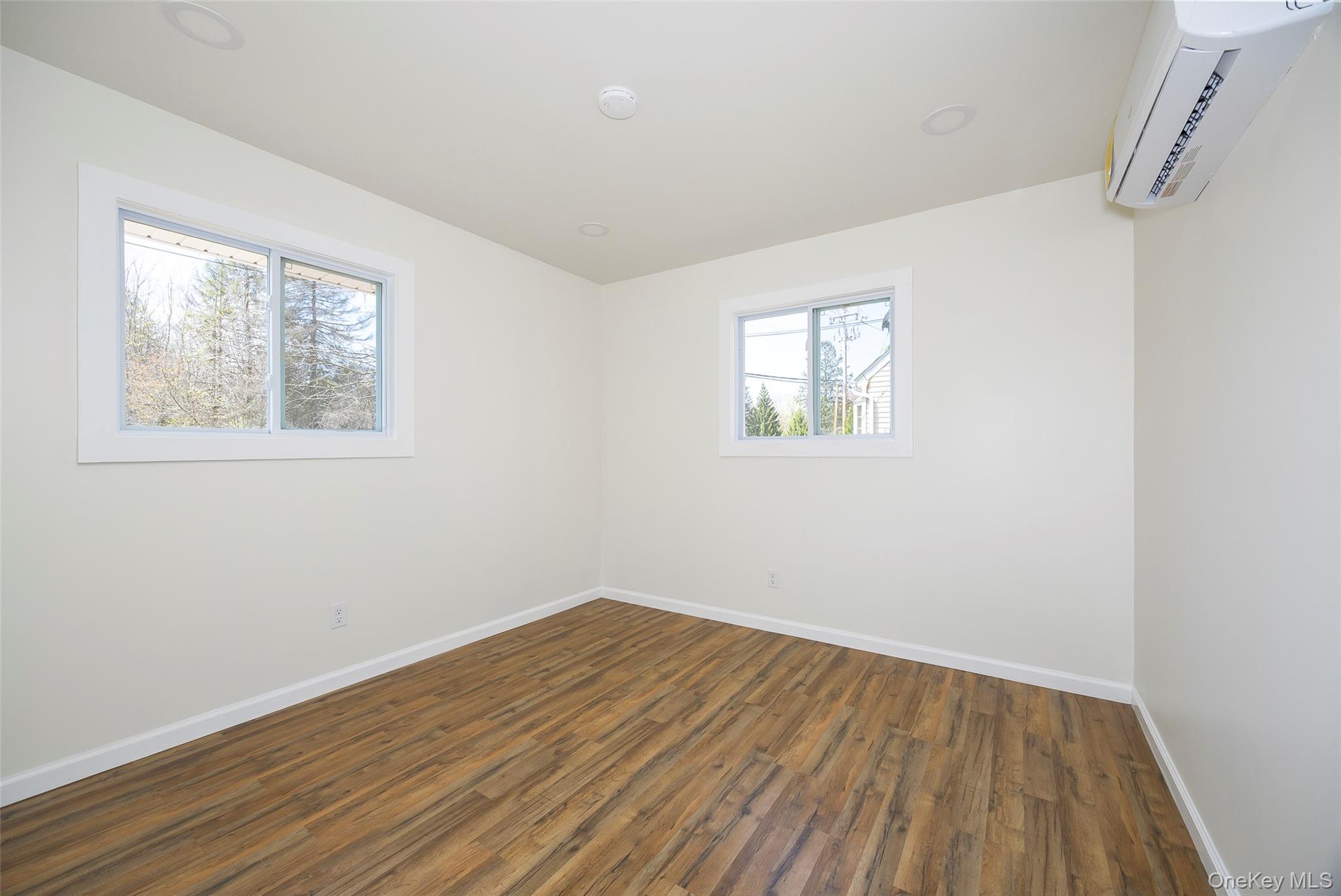 565 Old Hopewell Road Hopewell Junction, NY 12533 - Photo 13 of 23 Spare room with dark wood-style floors and a wall unit AC