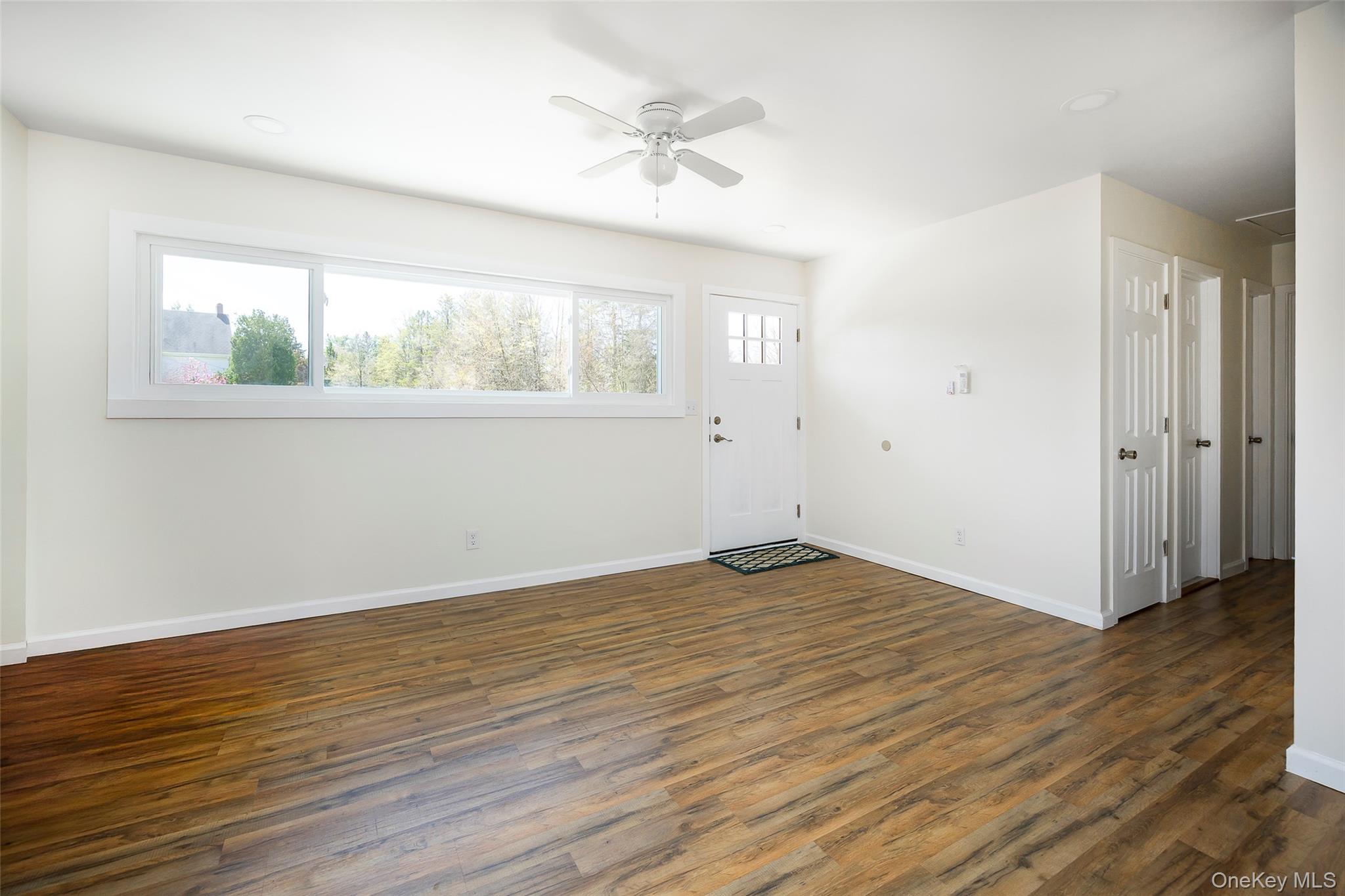 565 Old Hopewell Road Hopewell Junction, NY 12533 - Photo 2 of 23 Entrance foyer featuring dark wood-style floors and ceiling fan