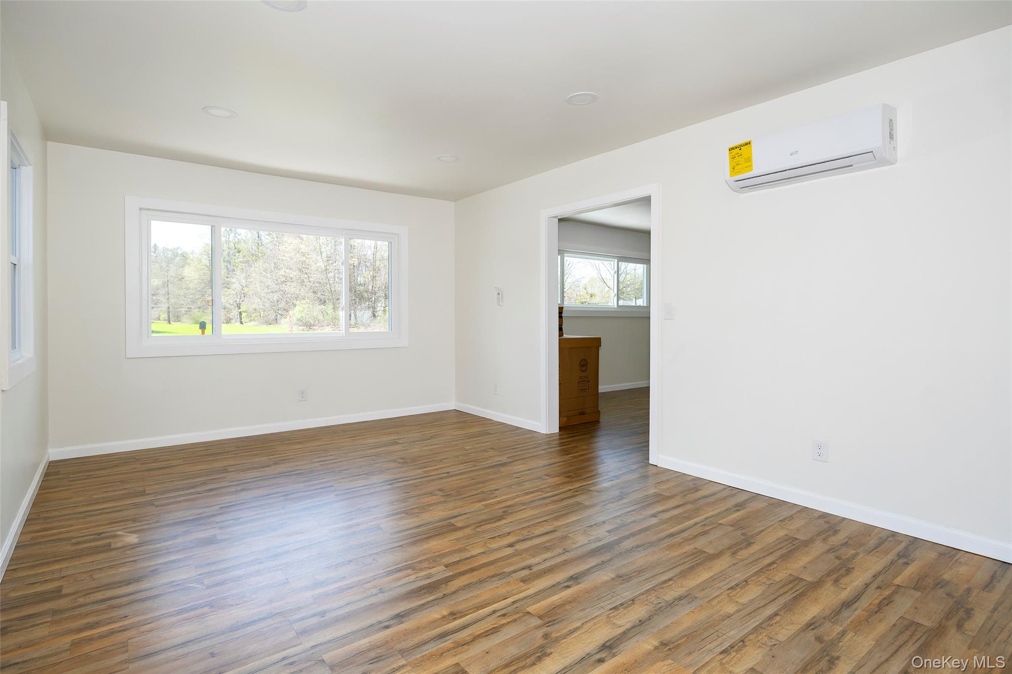 565 Old Hopewell Road Hopewell Junction, NY 12533 - Photo 6 of 23 Unfurnished room with wood finished floors and a wall unit AC