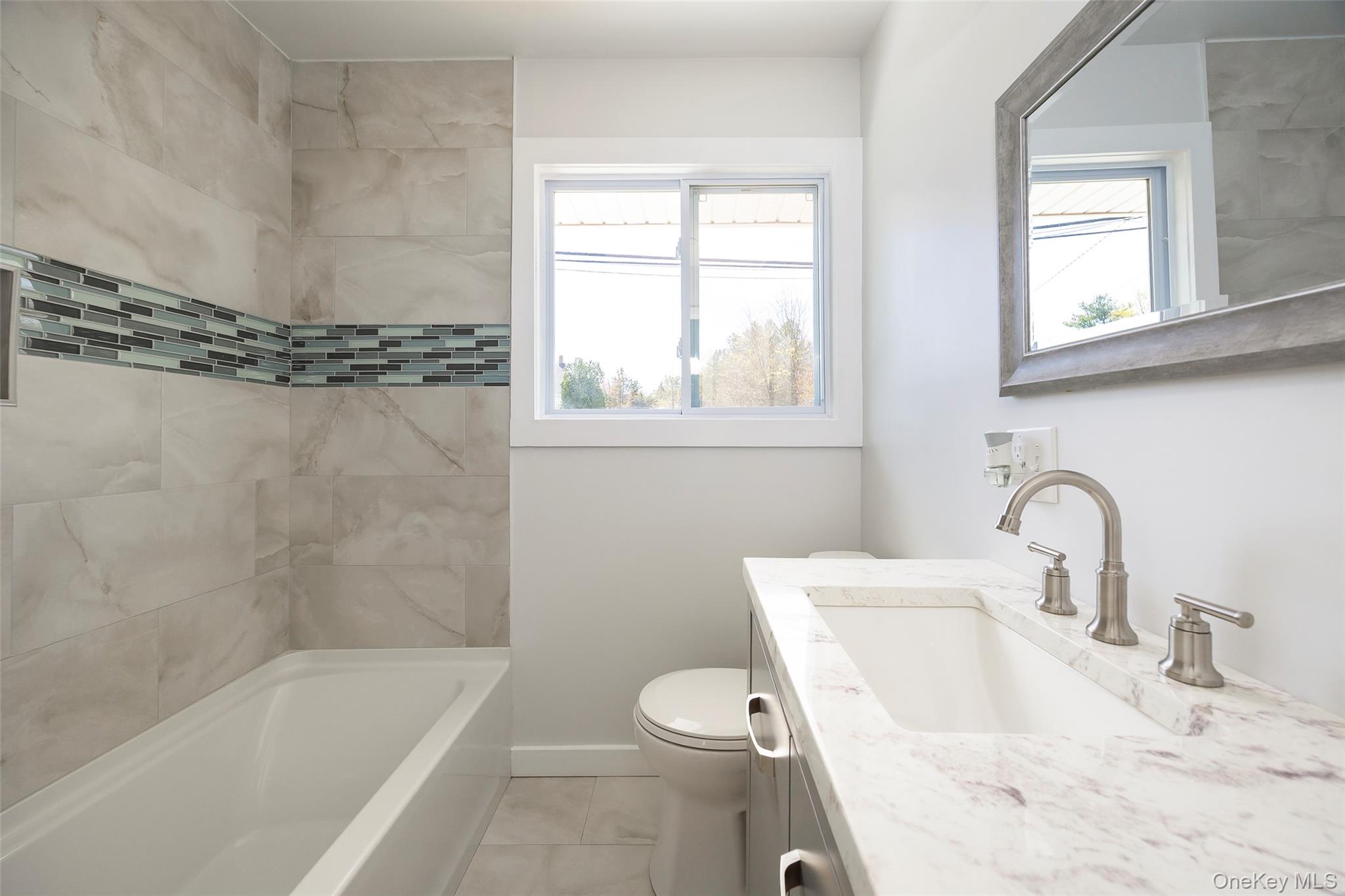 565 Old Hopewell Road Hopewell Junction, NY 12533 - Photo 8 of 23 Bathroom featuring vanity, plenty of natural light, and shower / tub combination
