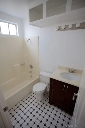 a bathroom with a sink a toilet and a bathtub