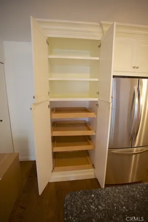 a view of walk in closet with empty racks