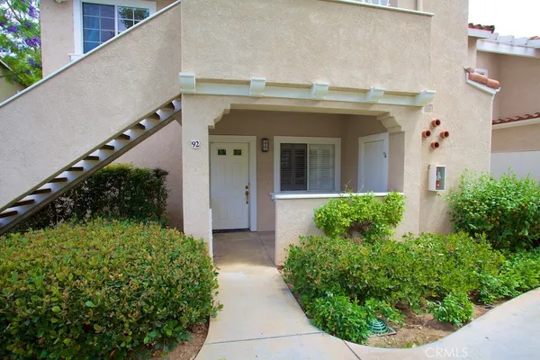 a view of a house with potted plants